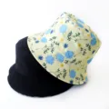 Detailed view of reversible black and floral print bucket hats - Adult 55-58cm / Floral Yellow