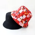 Detail shot of reversible bucket hat, black and red artistic digital print fabric design. - Style 18