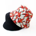 Detailed view of double-sided fashion bucket hat with abstract red print and solid black. - Style 23