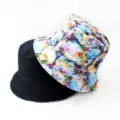 Detailed close-up view of reversible bucket hat, black solid and colorful floral sides. - Style 25
