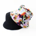 Closeup of the dual-sided bucket hat featuring a vibrant abstract print and solid black reverse. - Style 30