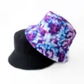 Detailed view of reversible bucket hat, black and purple tie-dye design, outdoor casual style. - Style 31