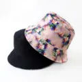 Detailed view of reversible bucket hat with black and digital floral print options. - Style 34