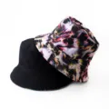 Close-up detail showing the reversible design with abstract fluid print and solid black. - Style 36