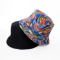 Detailed close-up view of the reversible bucket hat featuring classic black and vibrant print. - Style 39
