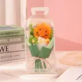 Detailed close-up of a handmade crochet sunflower bouquet inside a clear PVC gift box - Green Style (Hand-Carried Box)