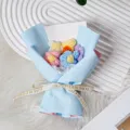 Detailed view of handmade crochet flower bouquet in blue wrapping paper with nice ribbon. - Blue Wrapping Paper Style