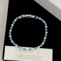 Detail of blue and clear square zircon bracelet with silver clasp on elegant prop card - Blue Rhombus Style (R5573) / Silver