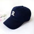 Detail of navy blue baseball cap with white embroidered R letter logo - Adult 55-58cm / Navy Blue