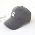 Detailed side view of a grey baseball cap featuring a white embroidered letter R - Adult 55-58cm / Gray