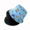 Reversible bucket hat detail featuring colorful butterfly print and solid black side for women. - Butterfly Blue