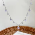 Elegant silver chain necklace adorned with multiple translucent purple crystal balls. - Necklace / Purple Style (R1650)
