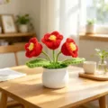 Handmade red crochet flowers in a white pot on a wooden table under natural sunlight. - 3-Head Lily of the Valley - Red