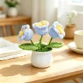 Macro detail of hand-woven blue crochet flowers in a minimalist white ceramic pot - 3-Head Lily of the Valley - Blue