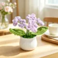 Macro view of handmade purple crocheted flower pot with pearl details on wooden table - 5-Head Gypsophila / Purple