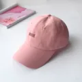 Detail view of pink baseball cap featuring 'BOOK' embroidery and soft top design - Adult Adjustable 55-59cm / BOOK Pink