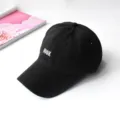 Close-up of a black cotton baseball cap featuring 'BOOK' letter embroidery - Adult Adjustable 55-59cm / Book Black