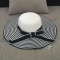 Elegant wide-brimmed straw sun hat with black and white stripes and a bow - M (56-58cm) / Striped Black
