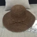 Handcrafted women's brown straw sun hat with elegant wide brim and delicate bow detail - M (56-58cm) / Handmade crochet Brown