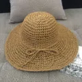 Women's wide-brim straw sun hat in natural khaki with a bow, perfect for beach holidays - M (56-58cm) / Hand Crochet Khaki
