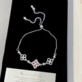 Close-up of elegant silver bracelet with orange zircon four-leaf flower charms - Bolo Four-leaf Flower Bracelet (R5811)