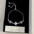 Close-up of adjustable silver bracelet with pink zircon flower motifs on black velvet - Bolo Four-leaf Flower Bracelet (R5814)