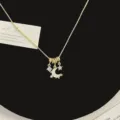 Close-up of elegant gold necklace featuring shell moon and star pendants with crystals - Shell Moon Necklace (R5701)