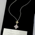 Detailed view of a luxury gold necklace with a purple four-leaf flower pendant on black velvet - Four-leaf Flower Necklace (R1994)