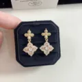 Detailed close-up view of vintage floral gold earrings with pink gemstones in a box - Four-leaf Flower Stud Earrings (R5109)