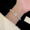 Elegante bracciale a farfalla in argento con perle rosa e catena regolabile - Bracciale Farfalla (R0472)