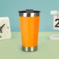 Portable 20oz stainless steel insulated coffee tumbler with lid for outdoor and travel use. - 20oz / Orange