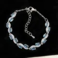 Elegante pulsera de plata con circonita azul claro ovalada y detalles brillantes - Estilo de Ola Azul Cielo (R1817)