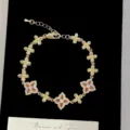 Elegante pulsera de flores doradas con circonitas cúbicas naranjas y blancas - Estilo de flor de cuatro hojas naranja (R2576) / Naranja