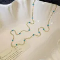 Elegant minimalist gold beaded necklace featuring vibrant turquoise natural stones for layering - Beaded Necklace