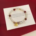 Elegant beaded bracelet with pearls, red beads and gold Fu charm on red background - Strawberry Quartz Fu Style (R2001) / Mixed Red