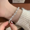 Elegant pearl and rhinestone bead elastic bracelet worn on wrist - Manta Pavé Ball Style (R0343) / White