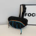 Black sporty waist bag featuring white star speckles and blue orange zipper accents - One Size / Black