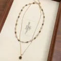 Detailed view of a double-layer necklace with natural tiger eye beads and round pendant - Double Layer Tiger's Eye Choker (R1265)