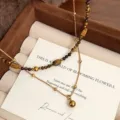 Macro view of a double-layer natural tiger eye beaded necklace in a luxury gift box - Double Layer Round Ball Tiger's Eye Necklace (R2678)