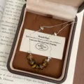 Macro view of vintage tiger's eye beaded necklace with adjustable chain in a jewelry box - Silver Choker Tiger's Eye Necklace (R1751)