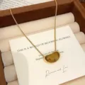 Elegant gold chain necklace featuring a natural tiger eye stone bean pendant jewelry - Cashew Pendant Tiger's Eye Necklace (R0234)