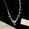 Detail of a sparkling zircon butterfly necklace with elegant mother-of-pearl inlay pendant - Mother Of Pearl Butterfly Y-Necklace (R5485)