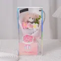 Close-up detail of a handmade pink crochet teddy bear bouquet in a transparent gift box - Knitted Rose + Teddy Bear + Gift Box + Card / Pink