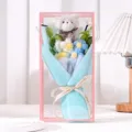 Close-up of handmade knitted bear and flower bouquet in pink transparent gift box - With LED Lights / Blue Puff Flower Bear