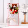 Close-up of a handmade crochet flower bouquet with a plush teddy bear in a gift box - With LED Lights / Red Puff Flower Bear