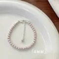 Elegant 4mm pink pearl bracelet with adjustable silver extension chain on a white plate - Bracelet / 4mm / Manta Purple