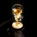 Detail der leuchtenden Goldfolienrose in einer Glaskuppel mit LED-Lichtern - Goldfolie Kleeblatt (Holzsockel)