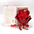 Detailed view of 7-count soap rose bouquet with plush teddy bear and pink gift bag - Red