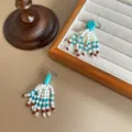 Detail shot of vintage Tibetan style beaded tassel earrings with turquoise and shell beads - Drop Earrings