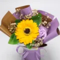 Details of the sunflower and soap rose bouquet with baby breath and purple gift wrapping. - Purple